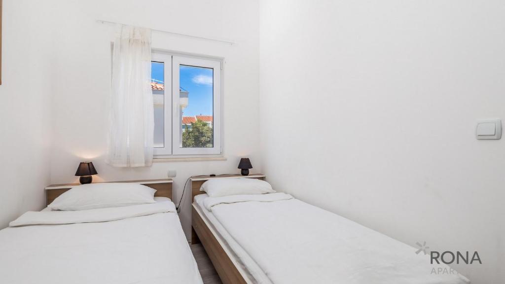 Postel nebo postele na pokoji v ubytování Rona Apartments Zlatko