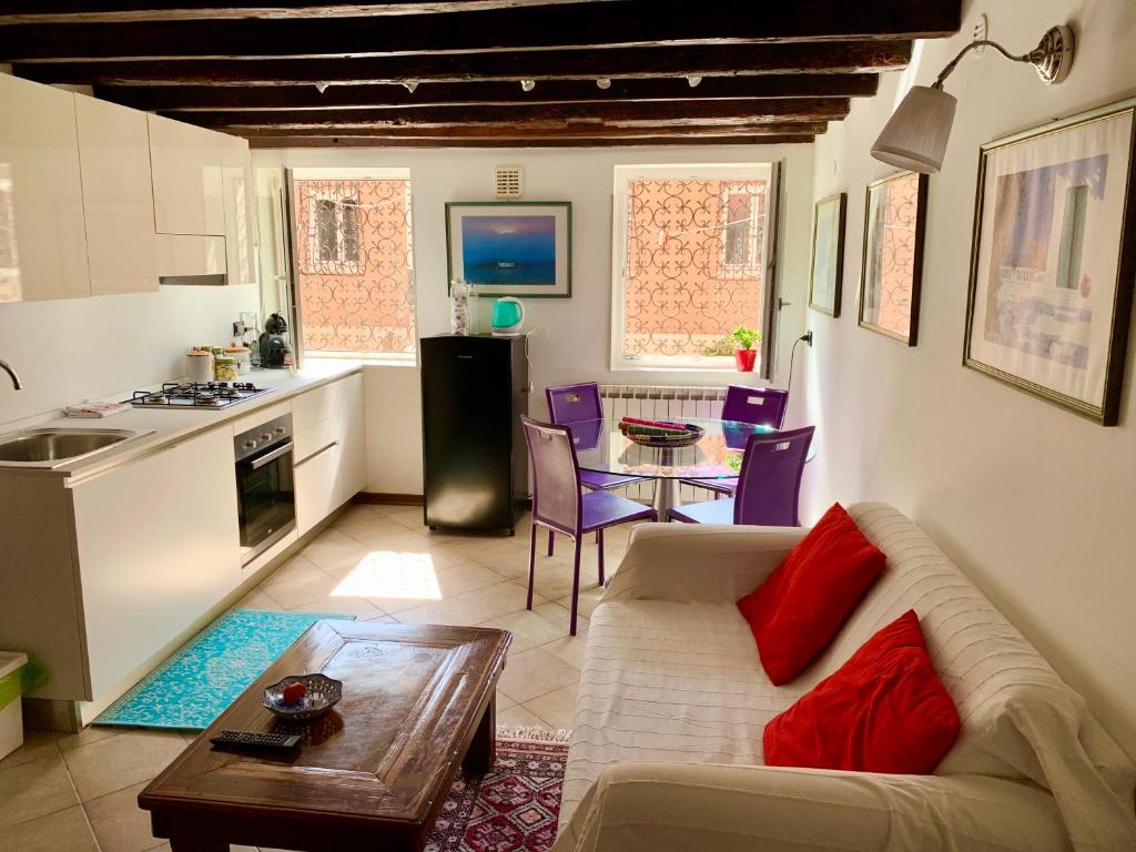 a kitchen and a living room with a couch and a table at Calle Zen Home in Venice