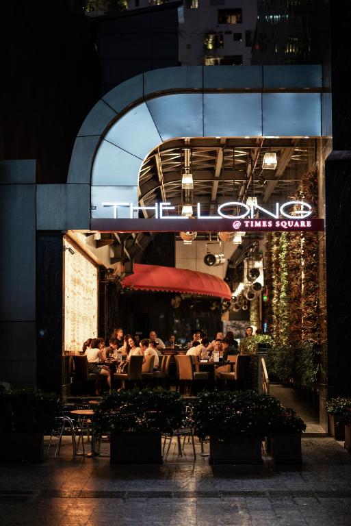a group of people sitting at a restaurant at night at The Reverie Saigon in Ho Chi Minh City