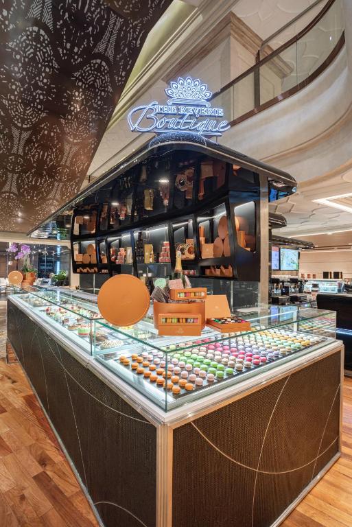 a display case in a store with a lot of food at The Reverie Saigon in Ho Chi Minh City