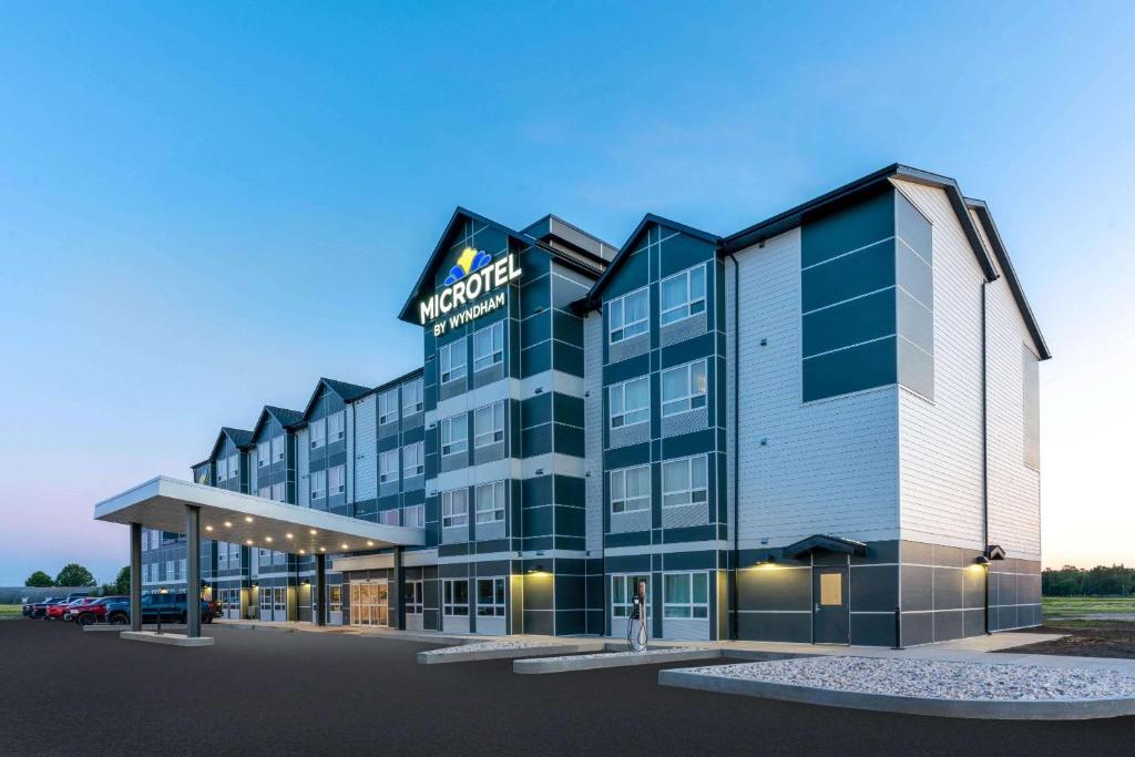 a rendering of the front of a hotel at Microtel Inn & Suites by Wyndham Portage La Prairie in Portage La Prairie