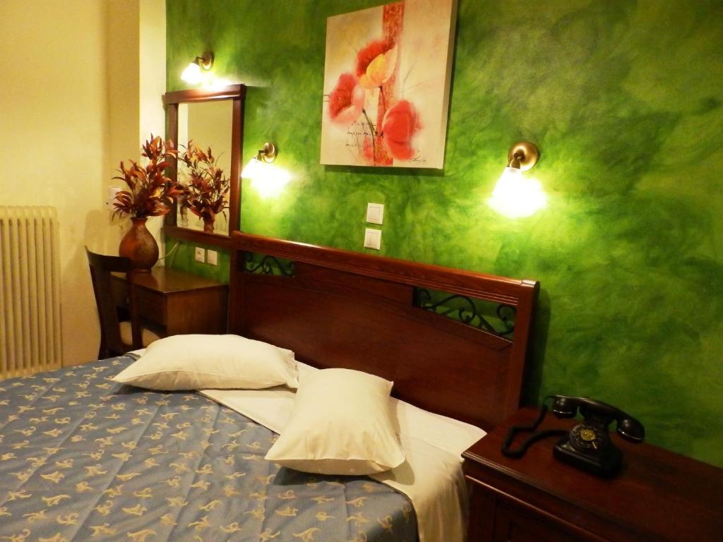 Postel nebo postele na pokoji v ubytování Pergamos Hotel
