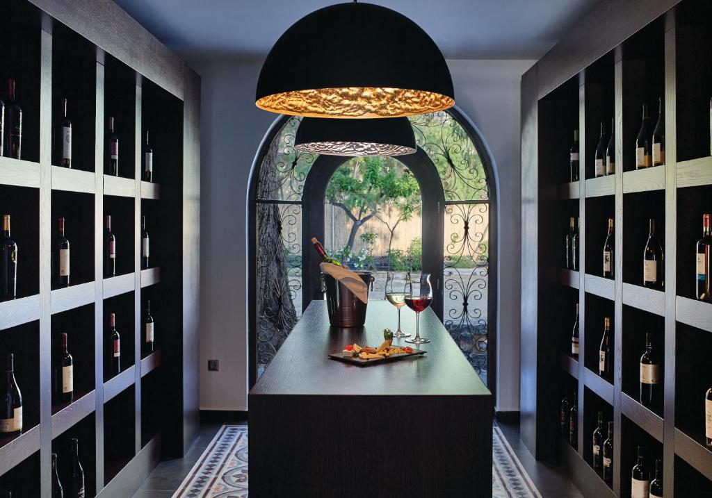 a tasting room with a table with wine glasses at Atlantica Akti Zeus Hotel in Amoudara Herakliou