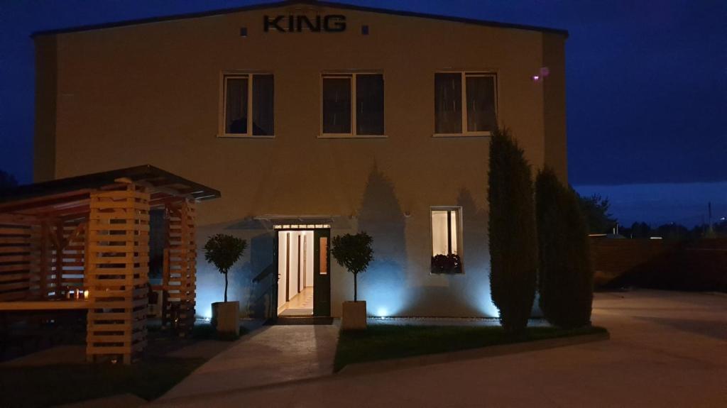 a building with a lit up door in front of it at KING Guest Inn in Drawsko Pomorskie