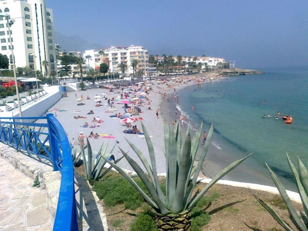 a beach with a lot of people in the water at AZAHARA 20 in Nerja