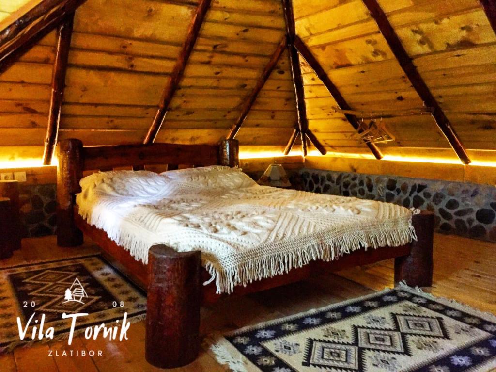 a bed in a room in a attic at Vila Mali Tornik in Zlatibor