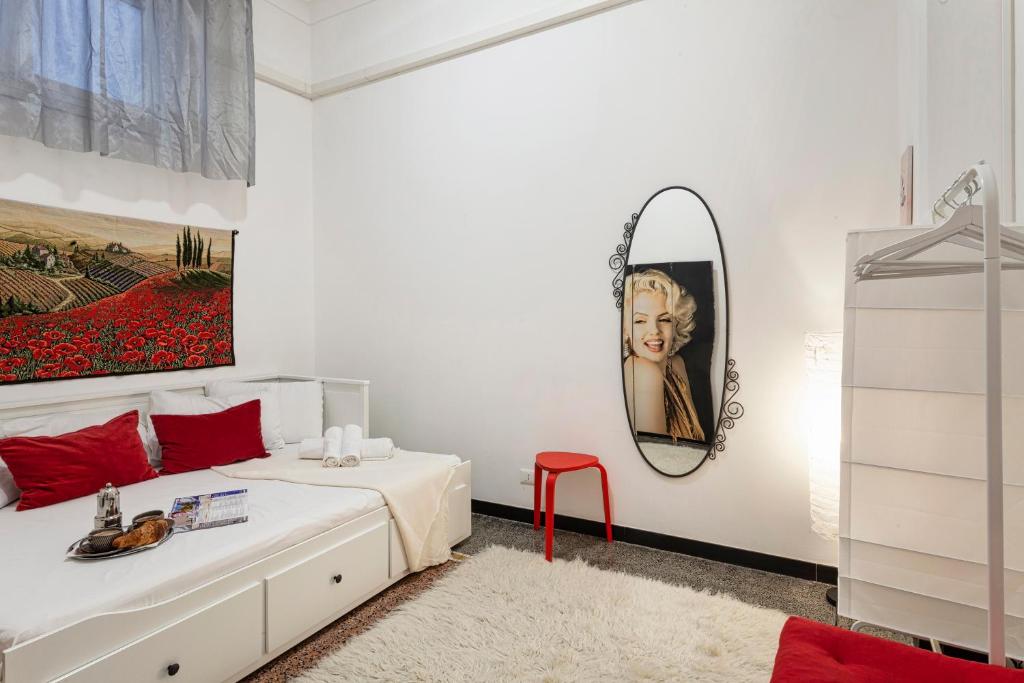 a bedroom with a bed and a mirror on the wall at Fantastic house near the station Free parking in Genoa