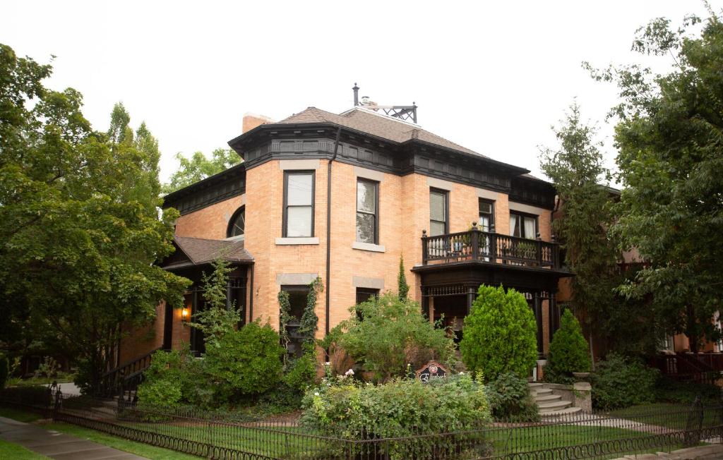 a large brick house with a balcony on it at Ellerbeck Bed & Breakfast in Salt Lake City