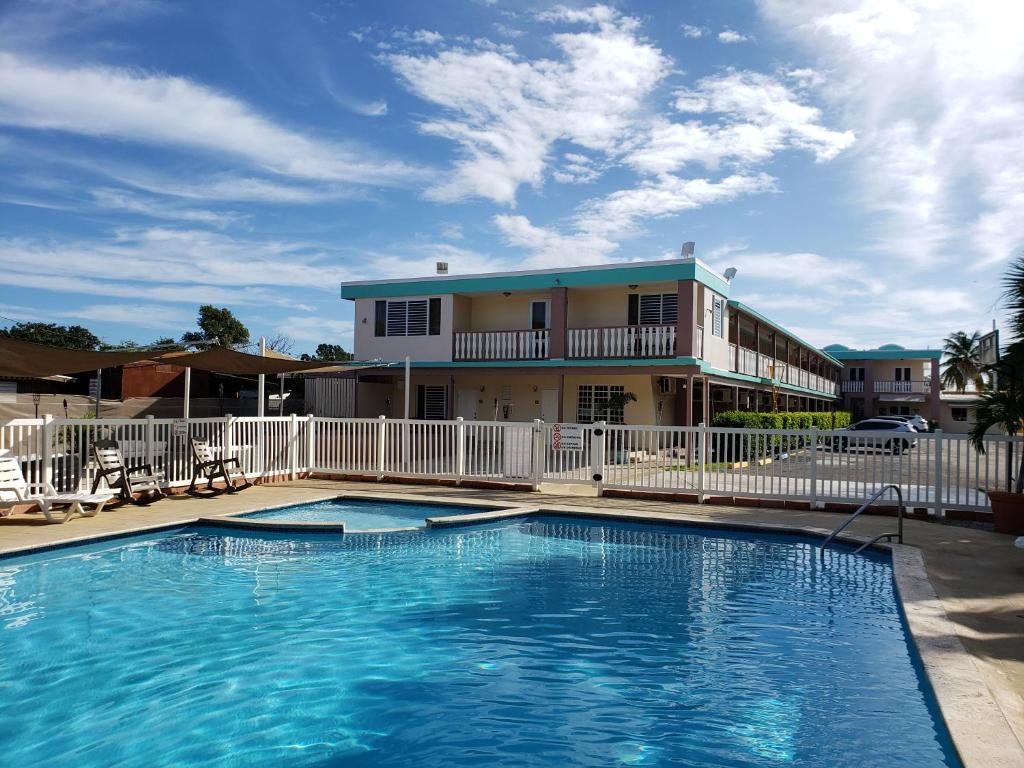 a large swimming pool in front of a building at Combate Beach Resort in Cabo Rojo