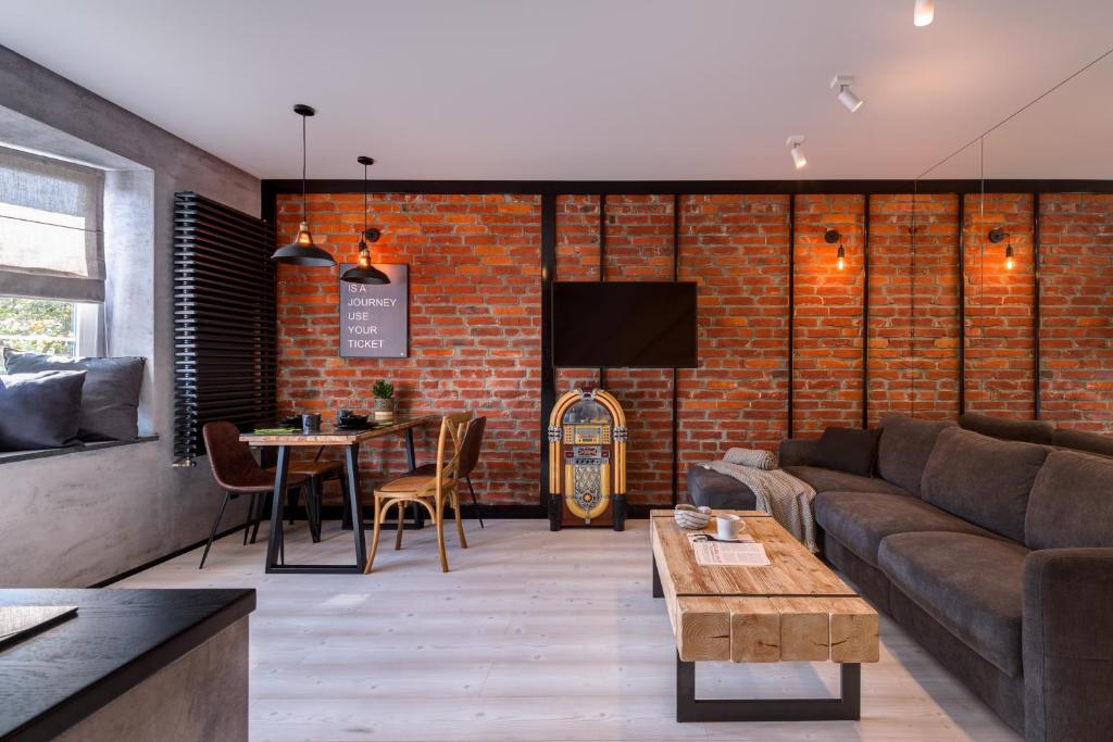 a living room with a couch and a table at Apartamenty Colobrzeg Loft in Kołobrzeg