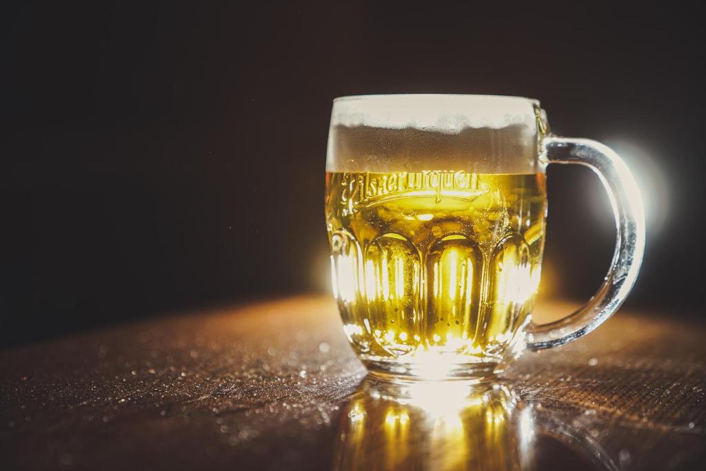 a glass of beer sitting on a table at Pension U Tří sedláků in České Budějovice