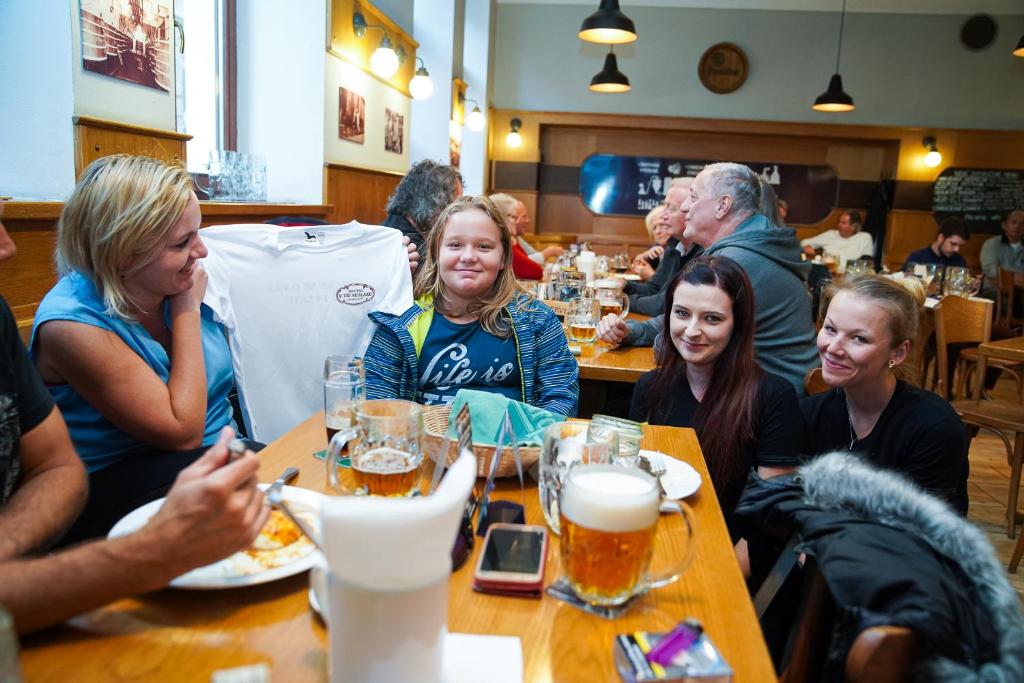 a group of people sitting at a table in a restaurant at Pension U Tří sedláků in České Budějovice