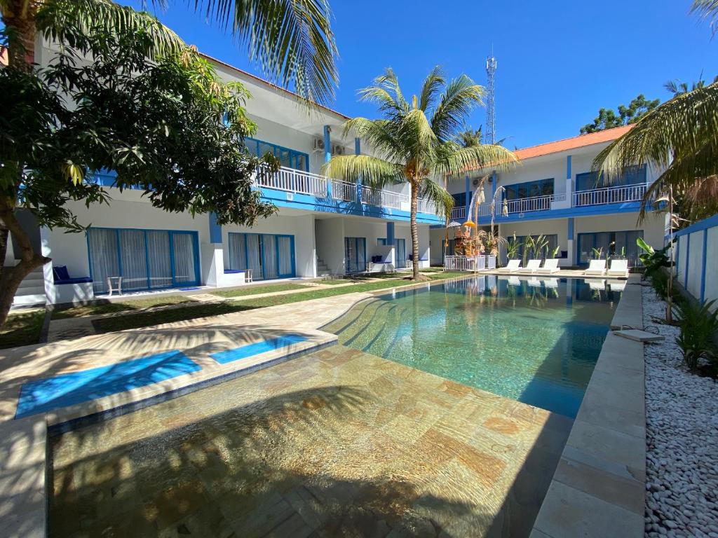 un complexe avec une piscine en face d'un bâtiment dans l'établissement Kura Kura Divers Lodge, à Amed