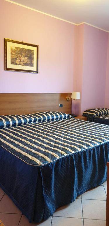 Postel nebo postele na pokoji v ubytování Hotel Scrivano
