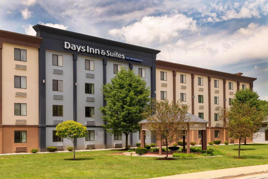 a large building with a clock on the front of it at Days Inn and Suites by Wyndham Hammond, IN in Hammond