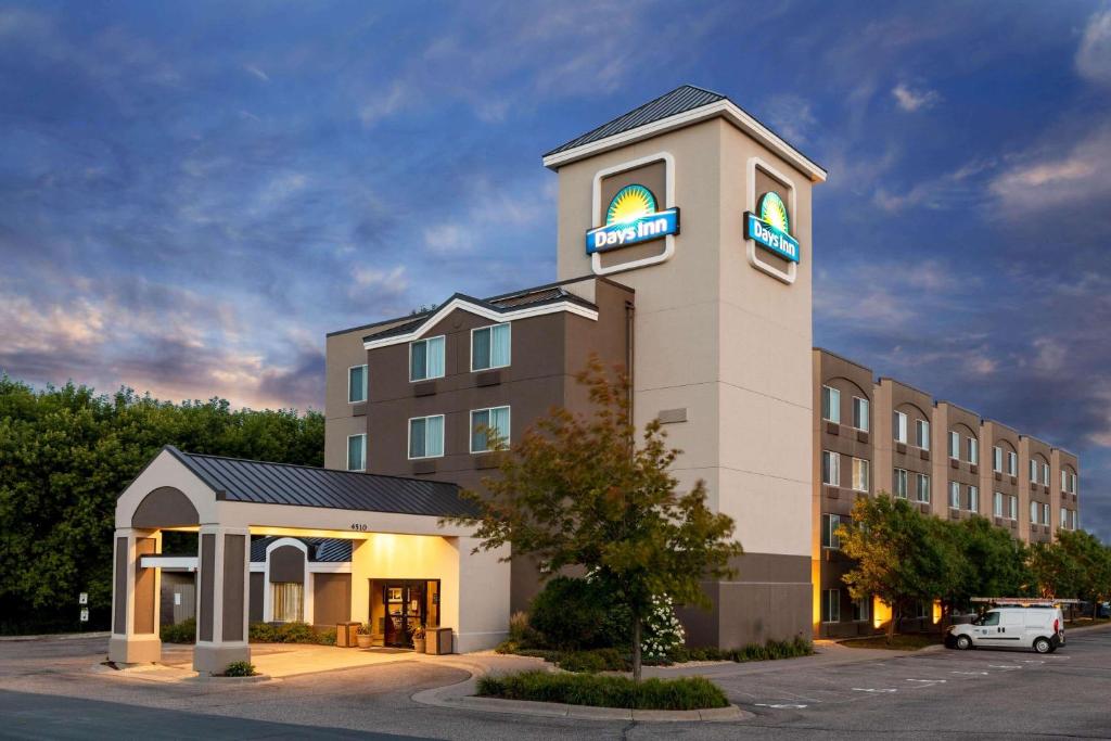 a hotel building with a sign on top of it at Days Inn by Wyndham Eagan Minnesota Near Mall of America in Eagan