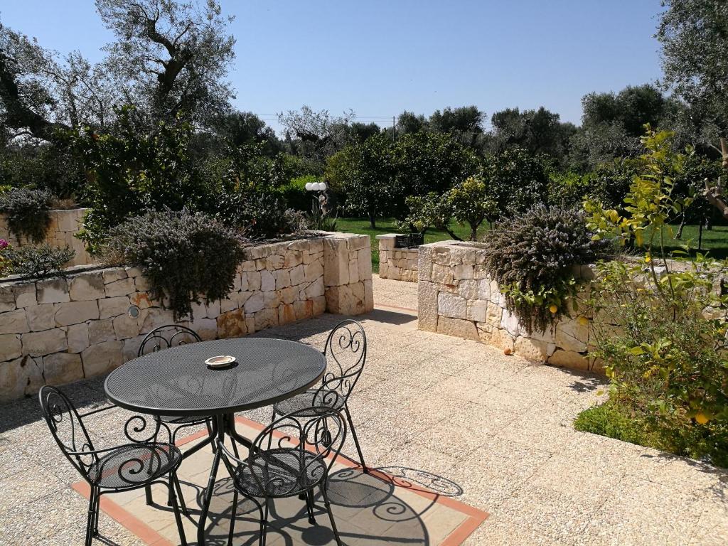 a table and chairs sitting on a patio at Masseria Asciano in Ostuni