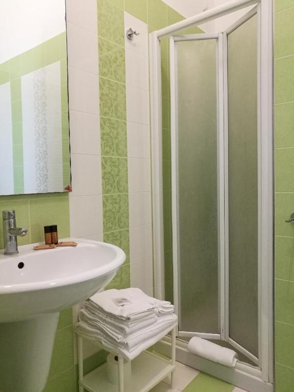 a bathroom with a sink and a shower at Masseria Asciano in Ostuni