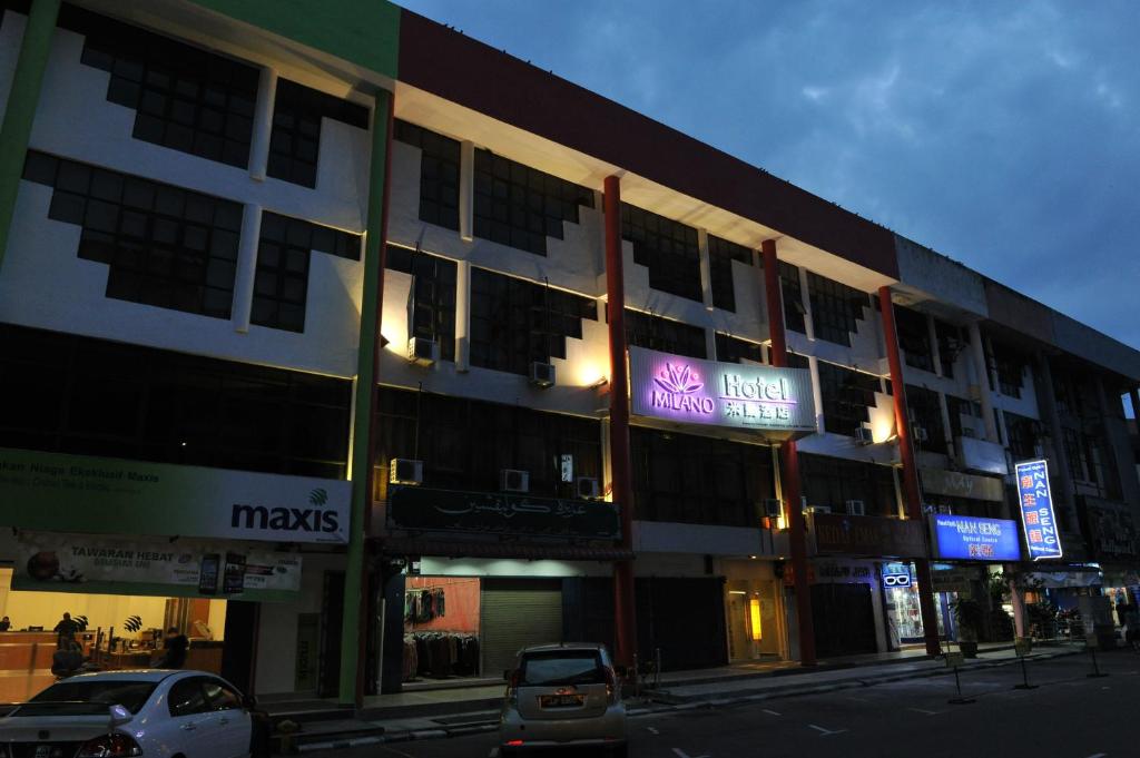 a building with a sign on the side of it at Milano Hotel in Kluang