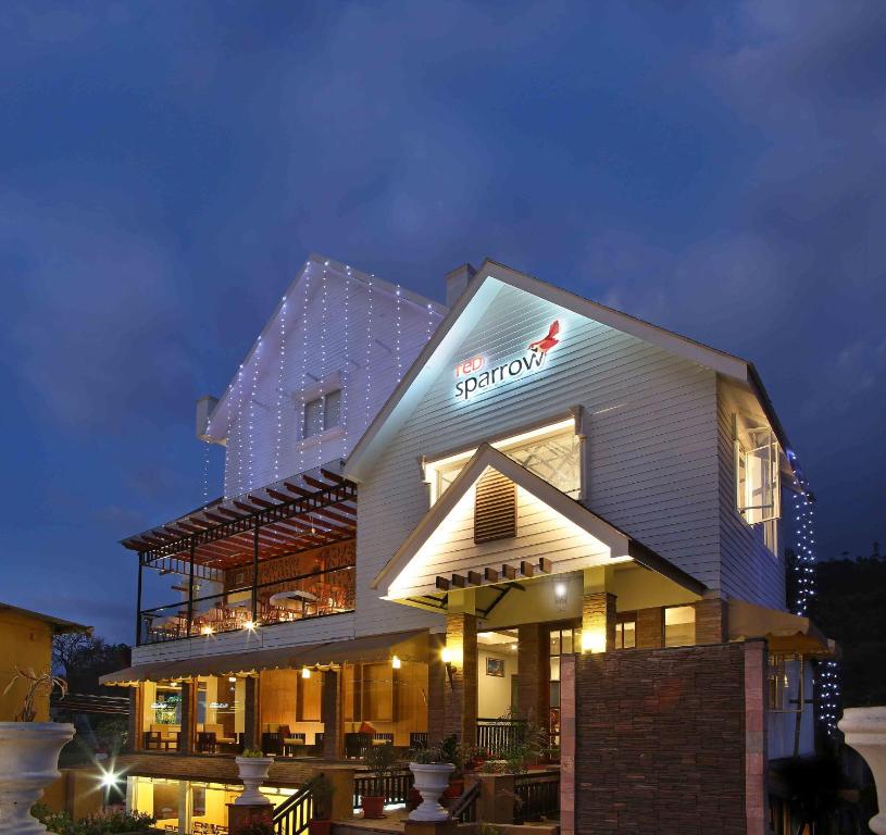 a building with a sign on the side of it at Red sparrow in Munnar