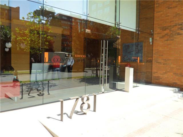 a glass window of a building with a person in it at La Concepcion, Providencia Suites in Santiago