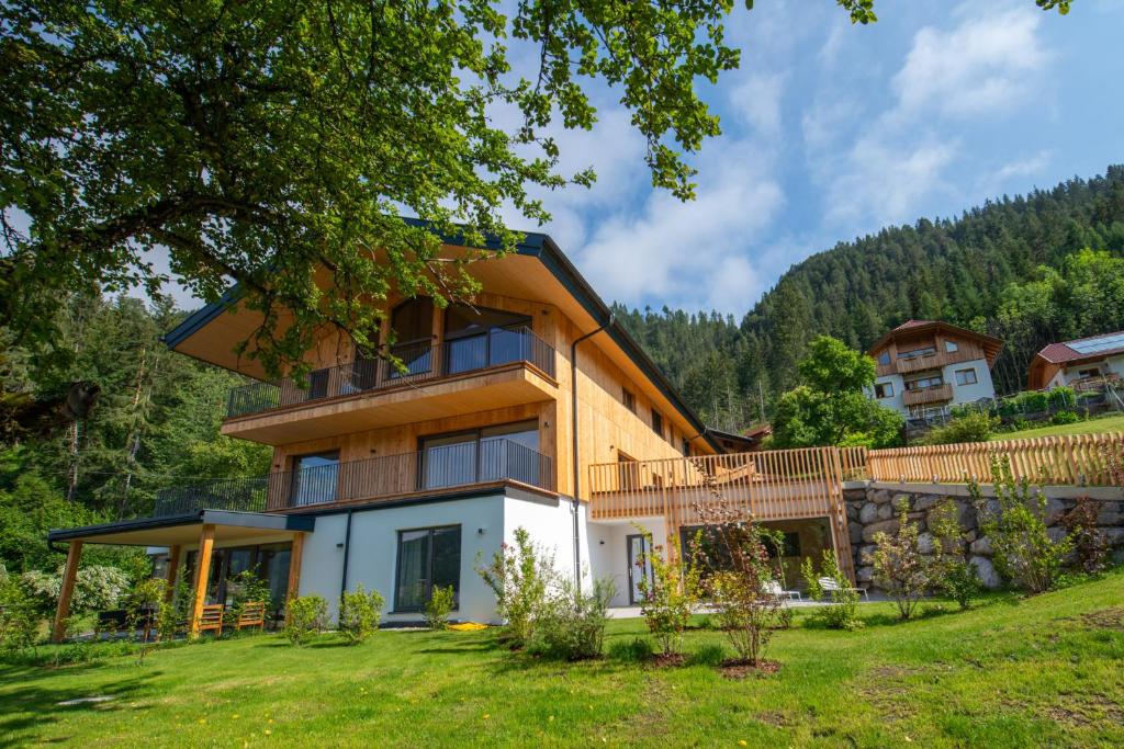 a house on a hill with a green yard at Neusach64 in Weissensee