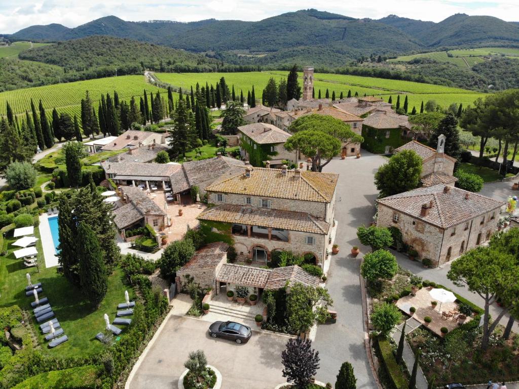an aerial view of a large estate with a mansion at Borgo San Felice in Castelnuovo Berardenga