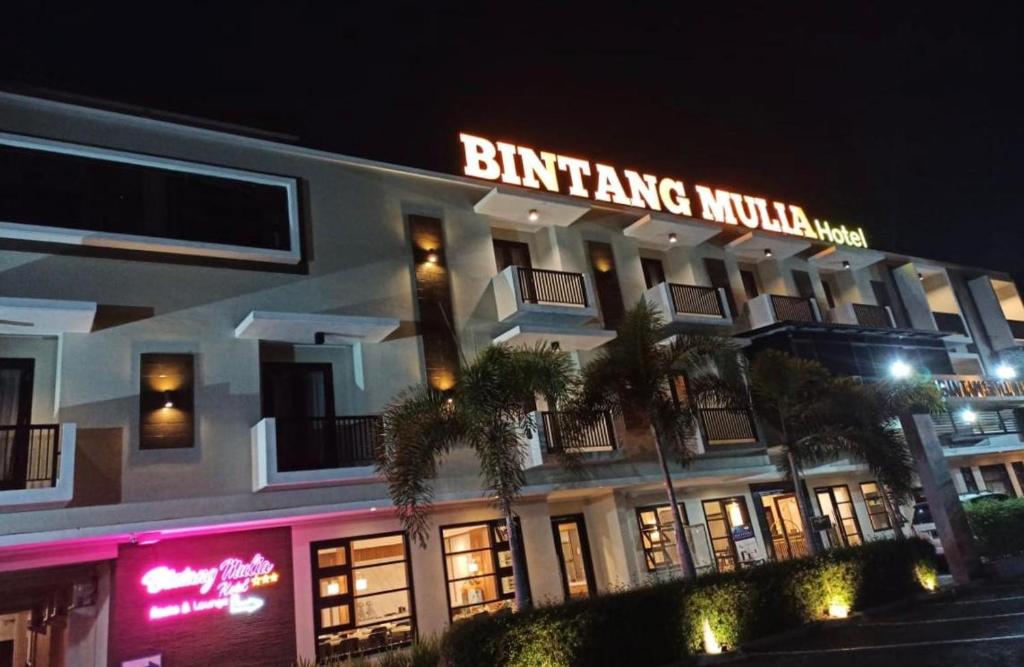 a building with a lit up sign on top of it at Bintang Mulia Hotel & Resto in Jember
