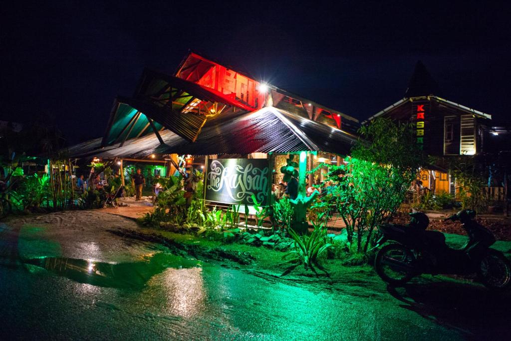 a building with green lights on it at night at The Kasbah Langkawi in Pantai Cenang
