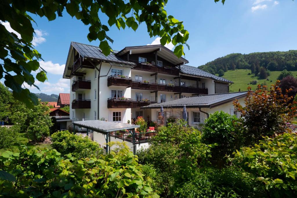 a hotel in the middle of a garden at Hotel Allgäuer Hof in Oberstaufen