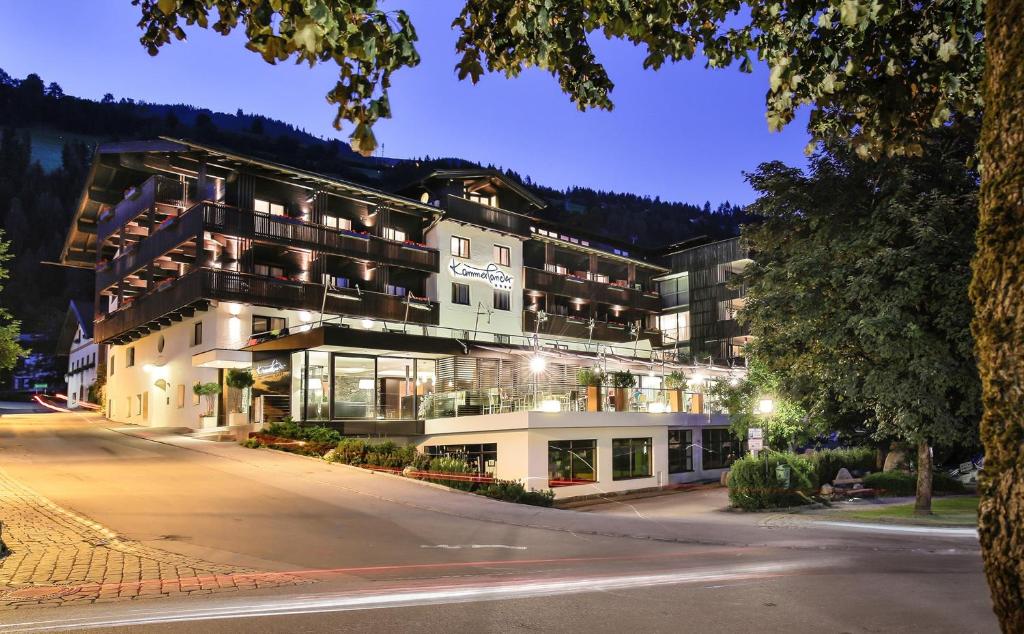 a large building with lights on at night at Hotel Kammerlander in Neukirchen am Großvenediger