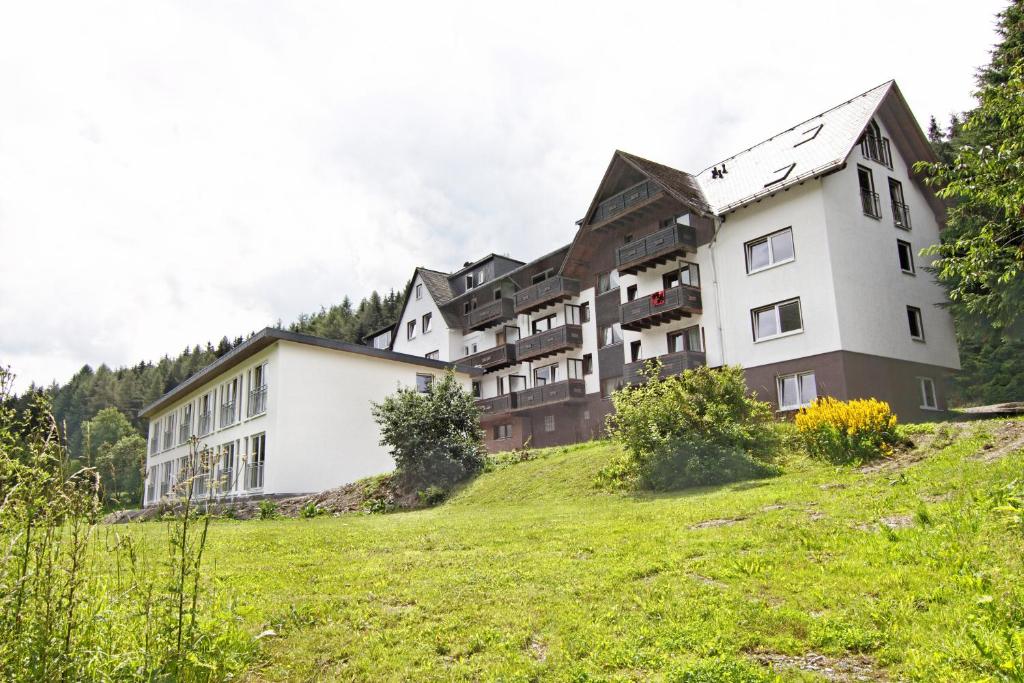a building on top of a grassy hill at Sonnenhof-Willingen in Willingen