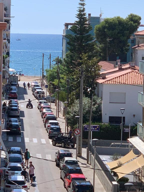 une rue avec des voitures garées sur le côté d'une plage dans l'établissement Calafell playa lateral mar, à Calafell