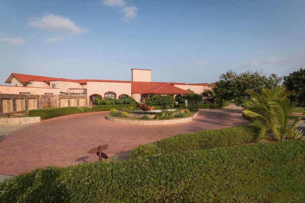 a large building with a road in front of it at Regenta Resort Bhuj by Royal Orchid Hotels Limited in Bhuj