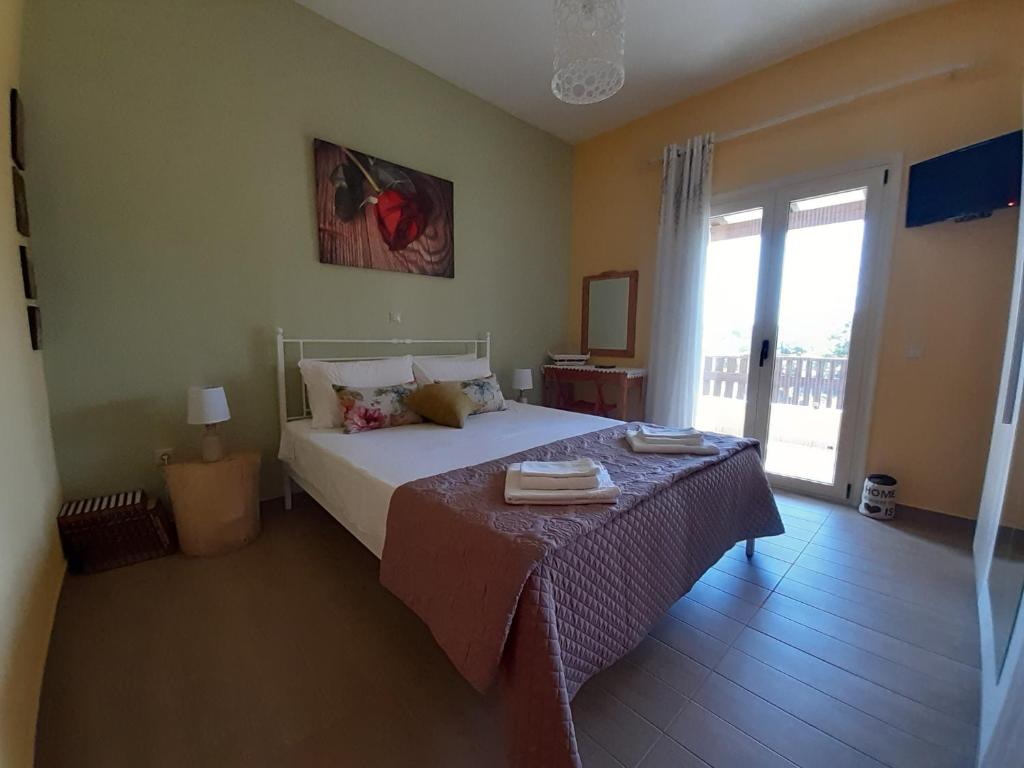 A bed or beds in a room at Andri House