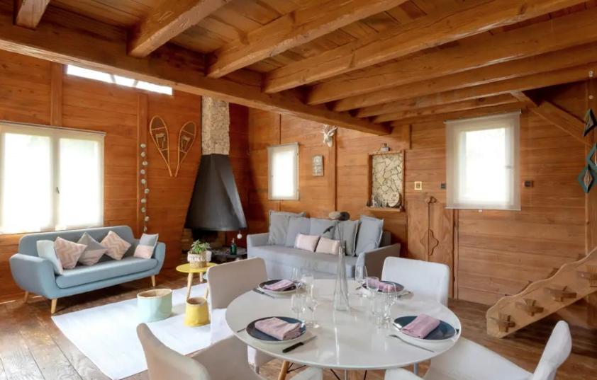 a living room with a table and a couch at L'Esprit Montpel "La Cabane-Chalet de Montagne" in Vendargues