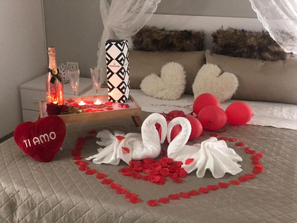 two swans made out of hearts on a bed at Dimora Vittoria in Bari