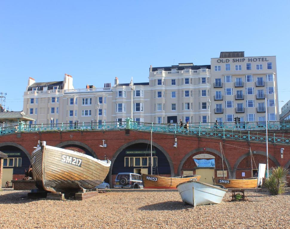 
a boat is parked in front of a building at The Old Ship Hotel- Part of the Cairn Collection in Brighton & Hove
