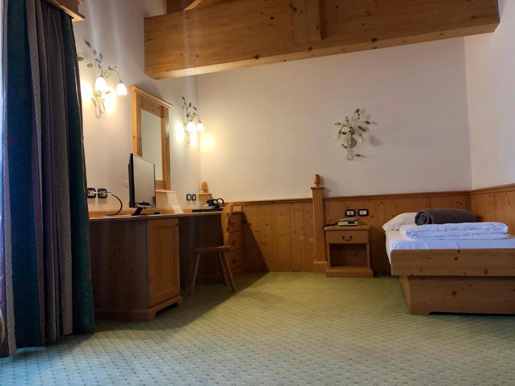 Postel nebo postele na pokoji v ubytování Domina Parco Dello Stelvio