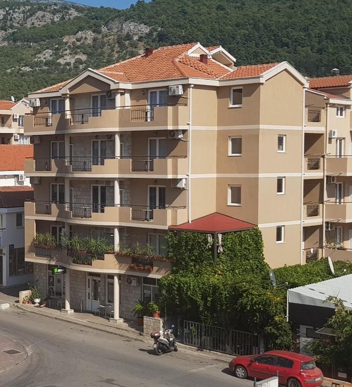 a large apartment building on the side of a street at Villa Pedja Zec in Budva