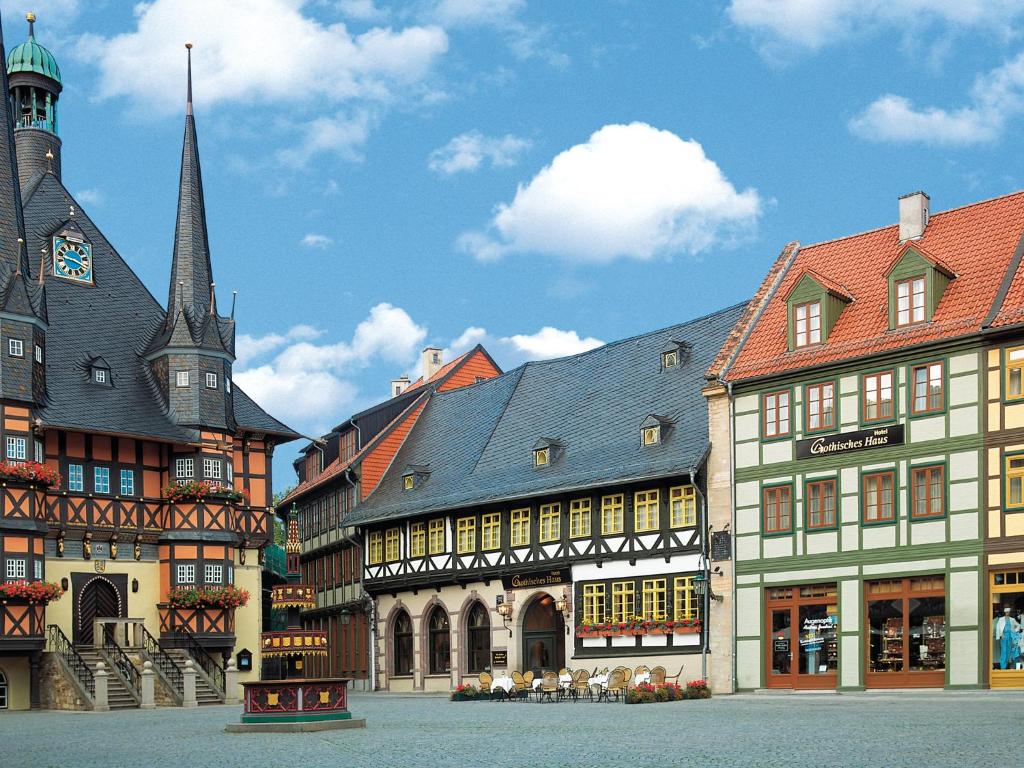 a group of buildings in a town with a church at Travel Charme Gothisches Haus in Wernigerode