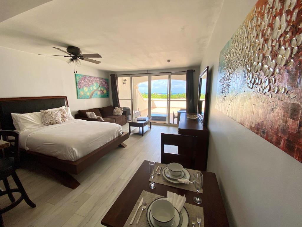 a bedroom with a bed and a living room at La Vista Azul Resort - Studio in Turtle Cove