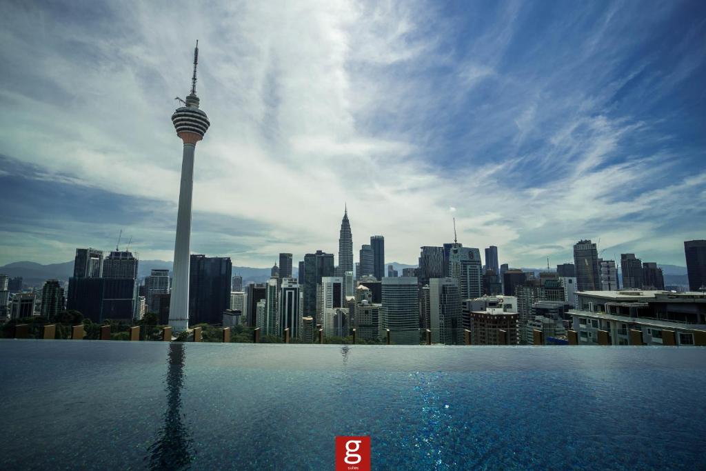 a view of a city skyline from a swimming pool at Ceylonz KLCC by Gsuites in Kuala Lumpur