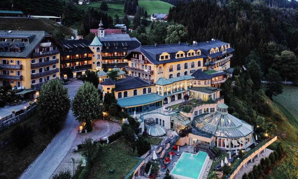 an aerial view of a large building with a pool at Hotel Pichlmayrgut in Schladming