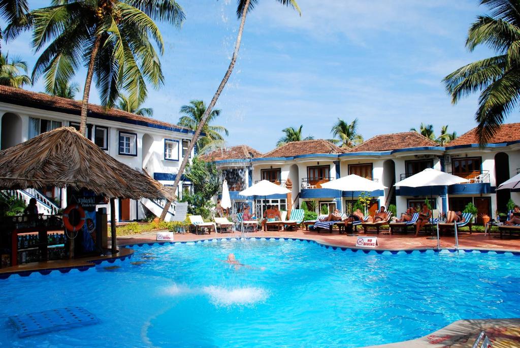 a swimming pool in front of a resort at Santana Beach Resort in Candolim