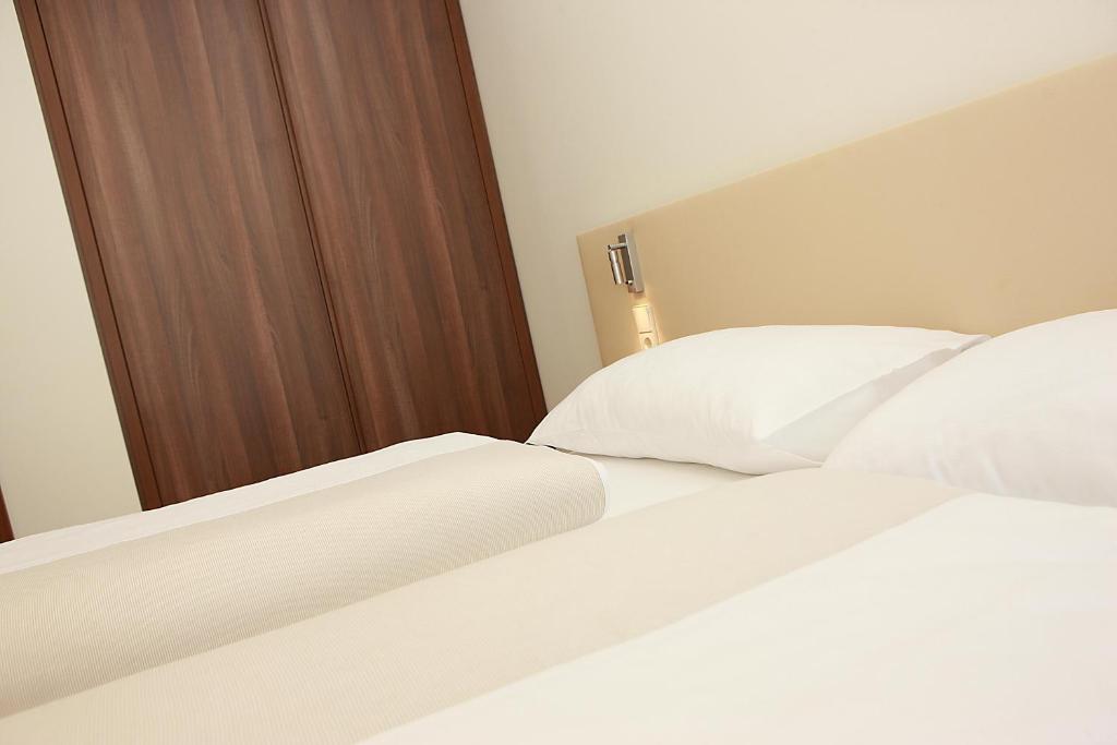 Postel nebo postele na pokoji v ubytování Appartementhaus Karawankenhof