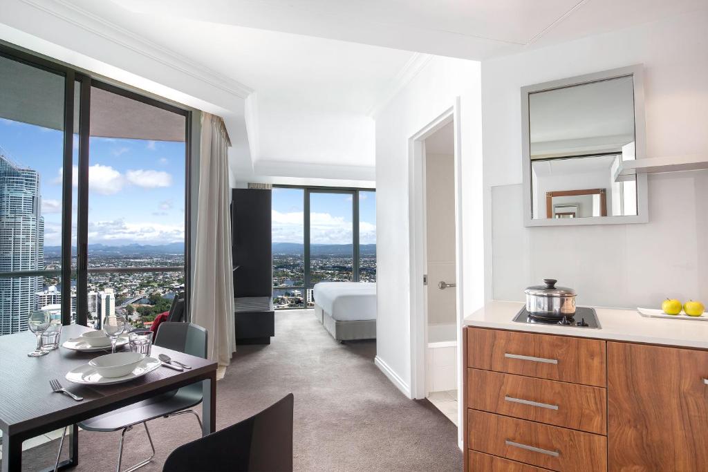 a kitchen and dining room with a view of a city at Mantra Legends Hotel in Gold Coast
