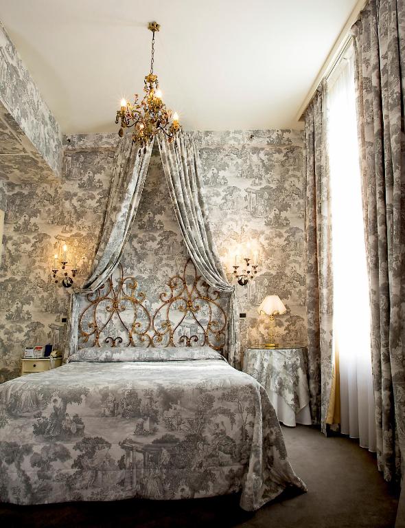 Postel nebo postele na pokoji v ubytování Hotel Principe