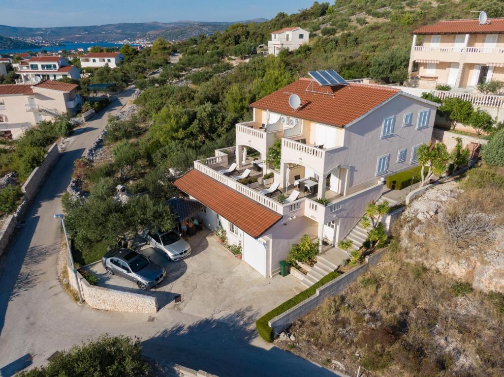 an aerial view of a large white house with a driveway at Apartments Matić in Rogoznica
