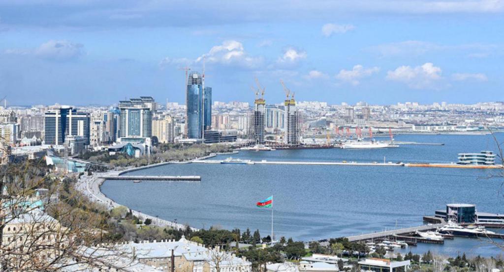 a view of a city with a river and a flag at Baku Panorama Hotel in Baku